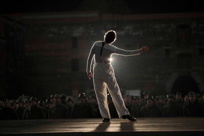 Marcel Marceau performs a dramatic pantomime show on stage in front of the soldiers